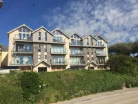 The Beach House & Porth Sands Apartments Hotels near The Bird