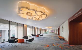 a large , modern room with multiple tables and chairs arranged for meetings or events , including a conference table in the middle at Hilton San Francisco Union Square