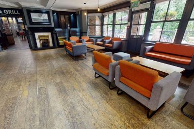 a large room with multiple chairs and couches arranged in a seating area , creating a comfortable and inviting atmosphere at Village Hotel Liverpool