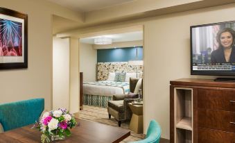 a small dining area with a table , chairs , and a tv mounted on the wall at The Kenilworth