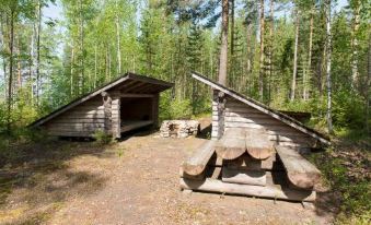 a hotel room with two beds , one on the left side and the other on the right side of the room at Karelian Country Cottages