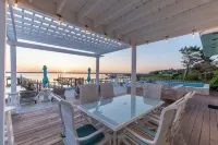 Waterfront home with dock, heated pool, & spectacular views- walk/bike downtown!