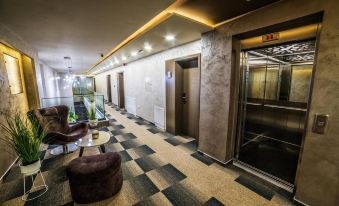 a hallway with two elevators , one on the left side and another on the right side at Hotel River