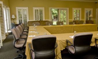 a conference room set up for a meeting , with chairs arranged in a semicircle around a long table at Glen-Ella Springs Inn