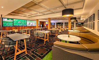 a modern restaurant with multiple dining tables and chairs , as well as a bar area at Blacktown Tavern