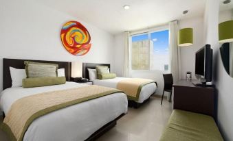 a modern hotel room with two beds , a window offering a view of the city , and a colorful spiral artwork on the wall at Hotel Mexico Plaza Irapuato