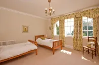 Manor house set in five acres of gardens with private golf course, near Ludlow.