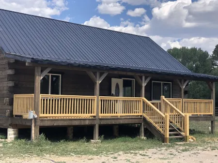 Beautiful hand-crafted log cabin on Horse Creek one block off Main Street.