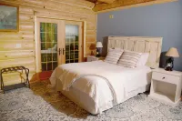 Beautiful log cabin in the woods with a hot tub. 5 min walk to a quiet beach. Hotels in Chippewa County