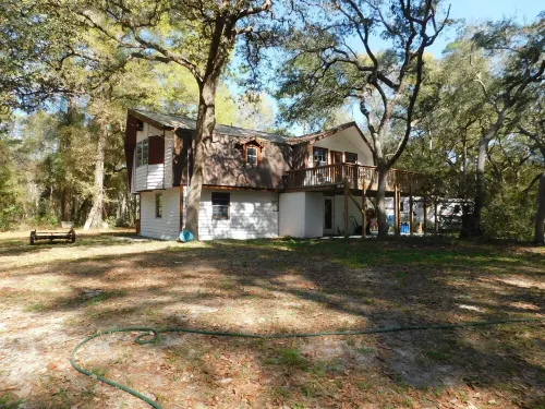 Country living at it's best! Rustic 1908 Barn nestled on 2.5 acres of old oaks