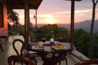 Ocean & mountain vistas, from the porches of this modern jungle perched villa.