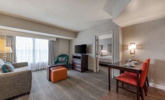 a hotel room with a living area , dining table , and tv , all set up for the day at Homewood Suites by Hilton Olmsted Village (Near Pinehurst, NC)