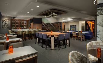 a large dining room with multiple tables and chairs arranged for a group of people to enjoy a meal together at Hyatt Centric Arlington