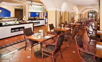 a large dining room with multiple tables and chairs arranged for a group of people to enjoy a meal together at Melia Panama Canal