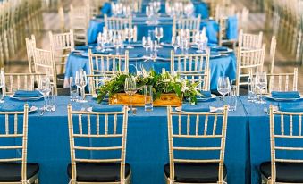 a long dining table set up for a formal event , with several chairs arranged around it at Seava Ho Tram Beach Resort