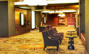 a large , empty conference room with multiple chairs arranged in rows , some of which are facing each other at DoubleTree by Hilton Reading