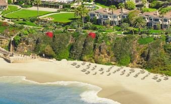 a beach resort with a large building in the background and a few smaller buildings nearby at Montage Laguna Beach