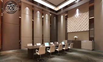 a modern conference room with a long table and white chairs arranged around it , creating a spacious and efficient atmosphere at Grand Singgie Hotel