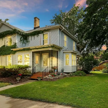 Historic house on tree lined red brick street of historic homes.