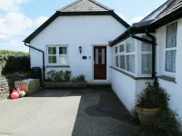 Honeysuckle Cottage with optional hot tub and shared EV charger.
