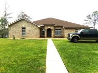 Enjoy this waterfront home with a pool, dock, and Blue Angels! Bring your boat!