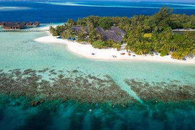 an aerial view of a tropical island with a sandy beach , palm trees , and clear blue water at Vilamendhoo Island Resort & Spa