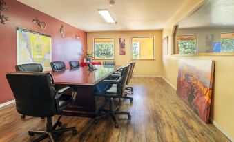 a conference room with a long wooden table and multiple chairs arranged around it , creating an open and inviting atmosphere at Ticaboo Lodge