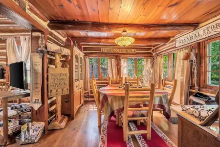 Rustic Rest Log Cabin, with hot tub and trout stream, near Poconos attractions.