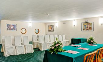 a conference room set up for a meeting , with chairs arranged in rows and a podium at the front at Hotel Antares