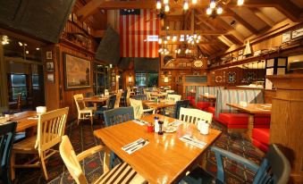 a restaurant with wooden tables and chairs , along with an american flag hanging from the ceiling at Disney's Vero Beach Resort
