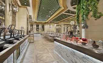 The restaurant features an open concept design with large tables and chairs at Hotel Alexandra