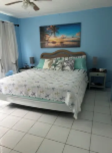 Tropical one bedroom condo steps from pool.