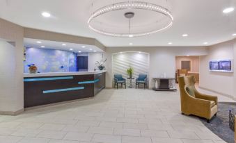 a modern hotel lobby with a blue and white checkered floor , a reception desk , and comfortable seating at SpringHill Suites Minneapolis Eden Prairie