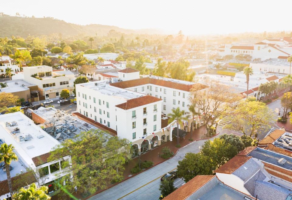 an aerial view of a city with a large white building in the center surrounded by trees and other buildings at Hotel Santa Barbara