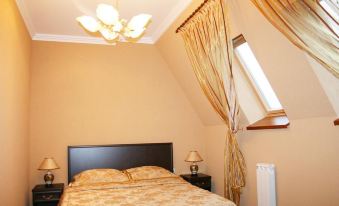 a cozy bedroom with a large bed , a lamp , and a window with curtains , providing ample light at Serebryanyy Bor
