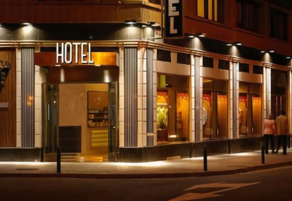 "a nighttime scene of a hotel building with its name "" hotel "" lit up on the side of the building" at Hotel Gran Via