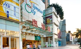 The entrance to a city is bustling with pedestrians walking in front and on both sides at Dorsett Mongkok Hong Kong