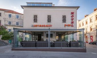 "a building with a sign that reads "" hotel "" and "" restaurant "" is shown behind a fence" at Hotel Park