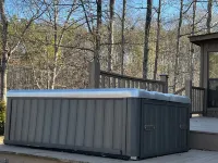 Cabin with hot tub, fire pit, and fishing pond.