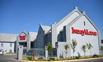 "a large building with the word "" indag "" prominently displayed on it , surrounded by a parking lot" at Indaba Lodge Gaborone