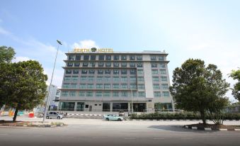 "a large white hotel building with the name "" herta hotel "" prominently displayed on its side , surrounded by trees and traffic" at Sem9 Senai "Formerly Known As Perth Hotel"