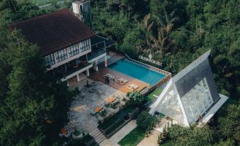 an aerial view of a large house surrounded by trees and a swimming pool in the backyard at Horison Green Forest Bandung