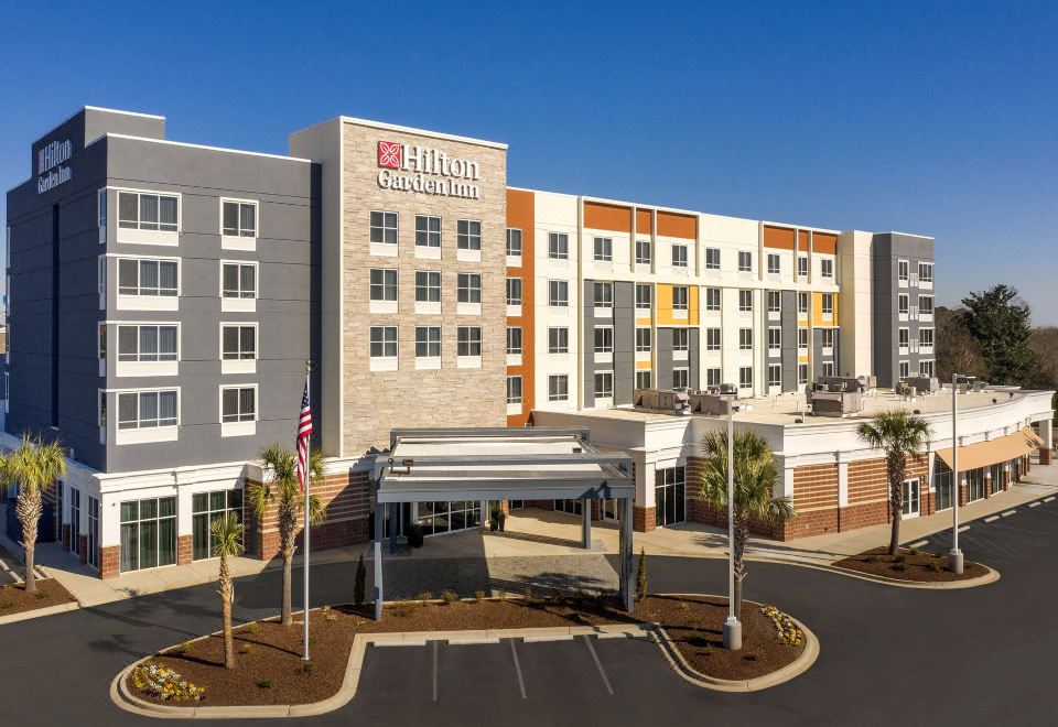 a hilton garden inn hotel with its logo and flags , situated in a city setting at Hilton Garden Inn Columbia Airport