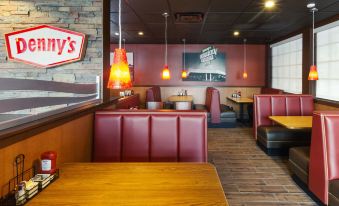 a fast food restaurant with multiple dining tables and chairs , as well as a sign on the wall at Best Western Plus Carriage Inn