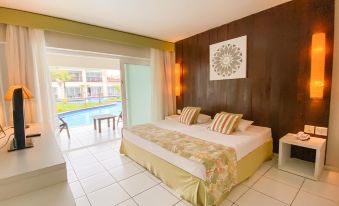 a hotel room with two beds , one on the left and one on the right side of the room at Búzios Beach Resort Luxo II