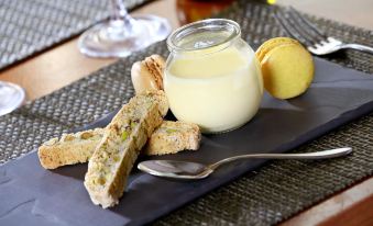 a dining table with a variety of food items , including bread , crackers , and a glass of milk at Macdonald Hill Valley Hotel, Golf and Spa