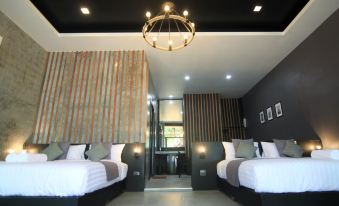 a modern hotel room with two beds , a chandelier , and a large window leading to a bathroom at Baan Chao Mai Beach House