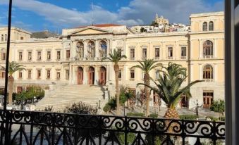 a beautiful , ornate building with a large courtyard and palm trees , viewed from a balcony at Habit