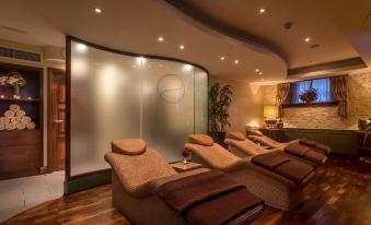 a modern spa room with several reclining chairs arranged in rows , creating a relaxing atmosphere at Oriel House Hotel