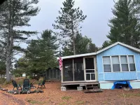 Parkmodel cabin w screened porch in campground on bike trail.